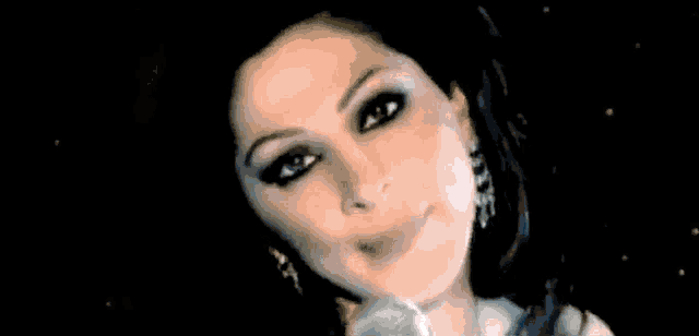 a close up of a woman 's face with a microphone in front of her