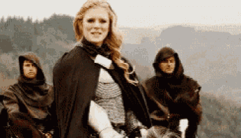 a woman in a knight 's armor is riding a horse with two men in hoods behind her .