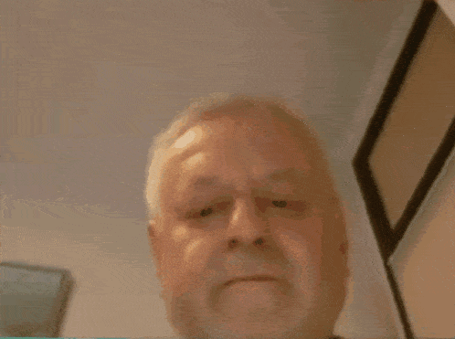 a blurry picture of a man 's face with a black shirt on