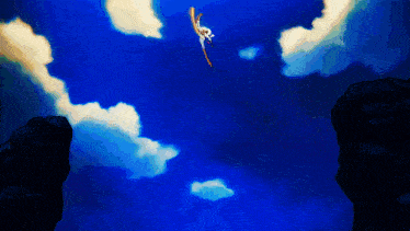 a person is flying through the air with a blue sky behind them