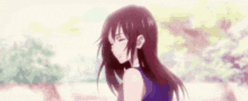 a girl with long red hair is standing in front of a tree and smiling .