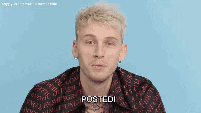 a man wearing a black and red shirt with the word posted on it
