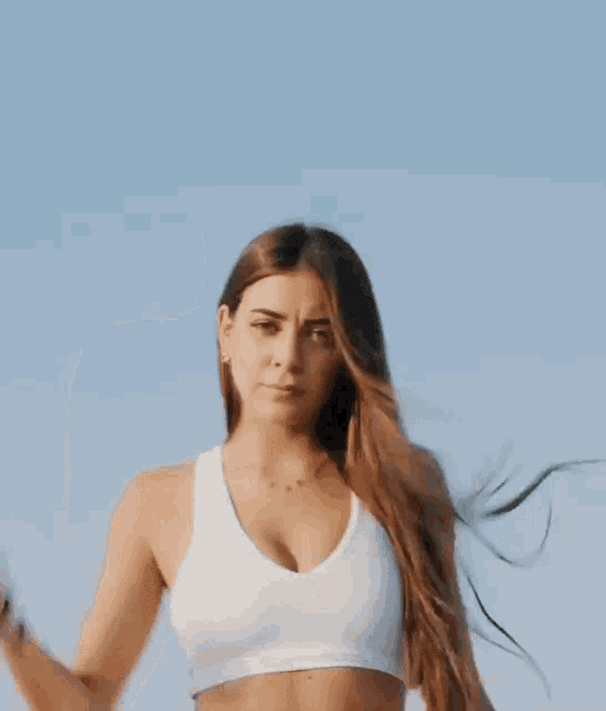 a woman in a white crop top and white shorts has a mexican flag on her waist