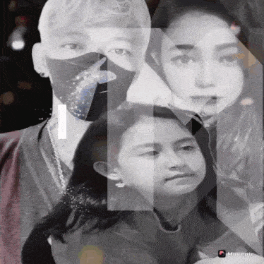 a black and white photo of a man a woman and a child with the letter n behind them