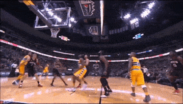 a basketball game is being played in a stadium with a pepsi banner on the ceiling