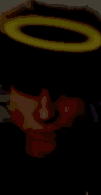 a blurry picture of a person with a yellow halo around their head .