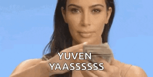 a woman is holding a stack of money in her hands and making a face .