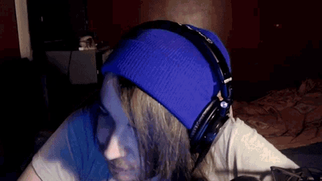 a man wearing a blue beanie and headphones