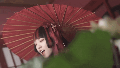 a girl with red hair and a red umbrella