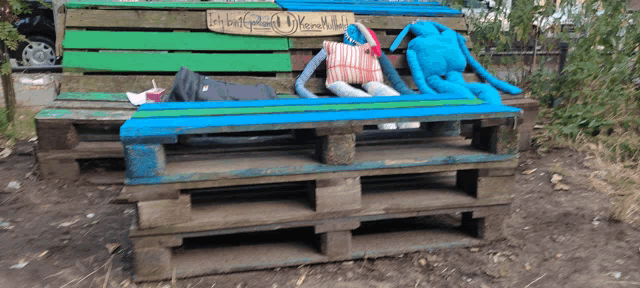 a wooden bench with a sign on it that says let 's build a better world