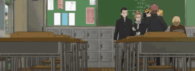 a group of people are standing in a classroom with a chalkboard that says ' a ' on it