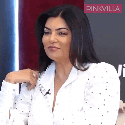 a woman wearing a white shirt with a pinkvilla logo on the bottom