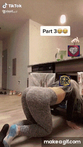 a woman is crawling under a table with a make a gif.com button