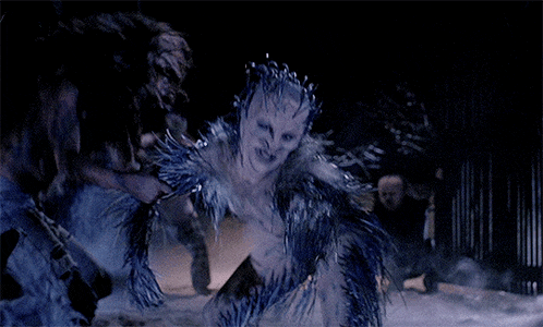 a woman with a crown on her head is being attacked by a werewolf