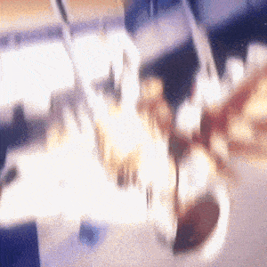 a blurry image of a person playing a violin with a purple background