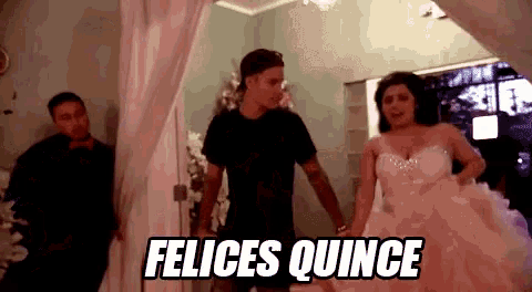 a man in a black shirt is standing next to a woman in a pink dress and a sign that says felices quince .