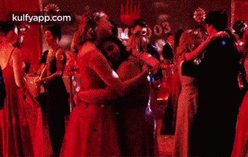 a man and a woman are dancing together at a party in a dark room .