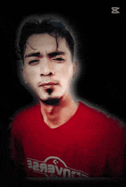 a man wearing a red shirt that says drcagaklae on it