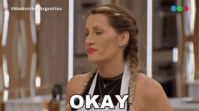 a woman says okay in front of a television screen