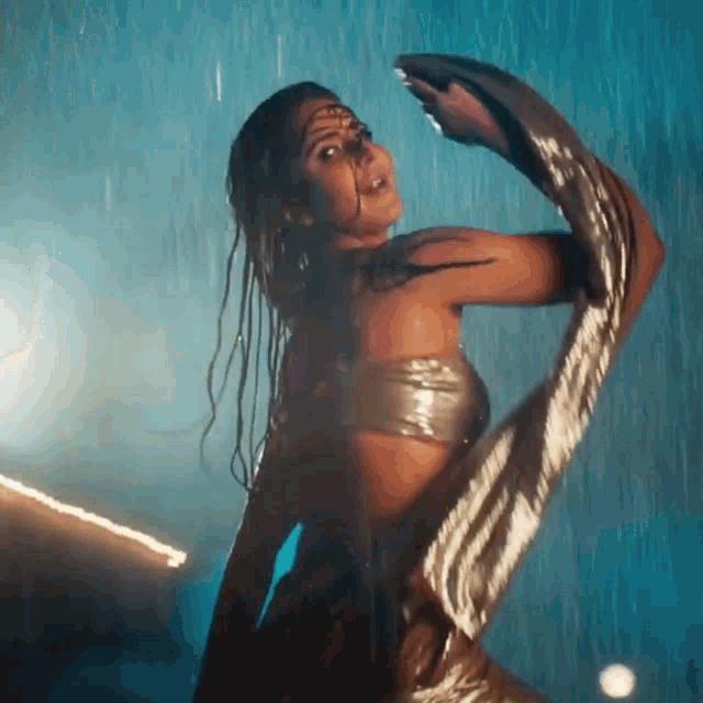 a woman is dancing in the rain in a wet top