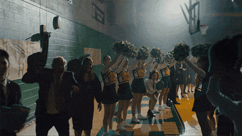cheerleaders in a gym with a sign that says ' a ' on it