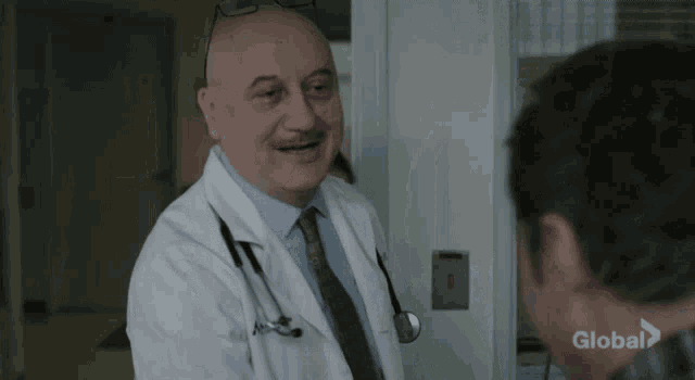 a man in a white lab coat is talking to a woman in a purple shirt