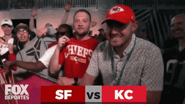 a man in a chiefs shirt is surrounded by fans
