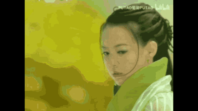 a close up of a woman 's face with the words putao written on the bottom