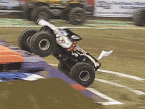 a black and white monster truck with a sticker on the side that says ' xtreme '