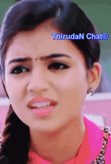 a close up of a woman 's face with the words thiruda n chat visible