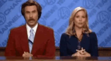 a man and a woman are sitting at a news desk in front of a channel 4 news background