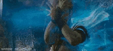 a person is standing in a dark room with a blue smoke coming out of their mouth