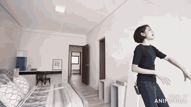 a woman standing in a bedroom with the words made in animatica on the bottom right
