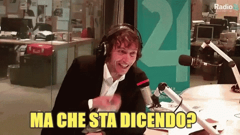 a man wearing headphones in front of a microphone says ma che sta dicendo ?