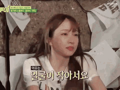 a girl with korean writing on her face is talking to someone