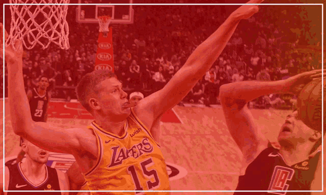 a basketball player wearing a yellow lakers jersey shoots a ball