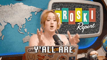 a woman speaking into a microphone in front of a screen that says ' the roski report '