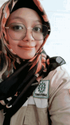a woman wearing glasses and a scarf has a patch on her jacket that says territorya2
