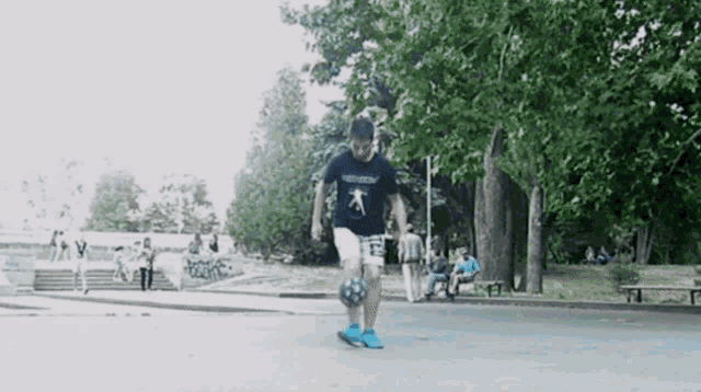 a person wearing a shirt that says ' freedom ' on it is kicking a soccer ball