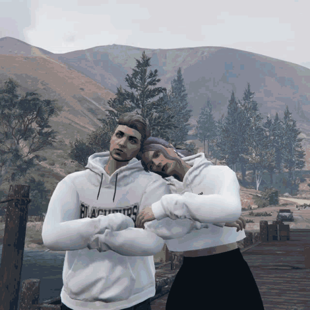 a man and a woman are posing for a picture and the man is wearing a hoodie that says beach boys