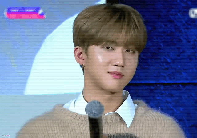 a close up of a person 's face with a microphone in front of them