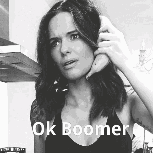 a woman is holding a banana to her ear with the words ok boomer written below her
