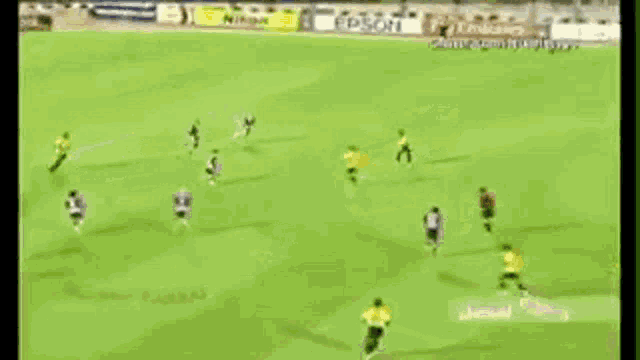 a soccer game is being played on a field with a samsung ad in the background