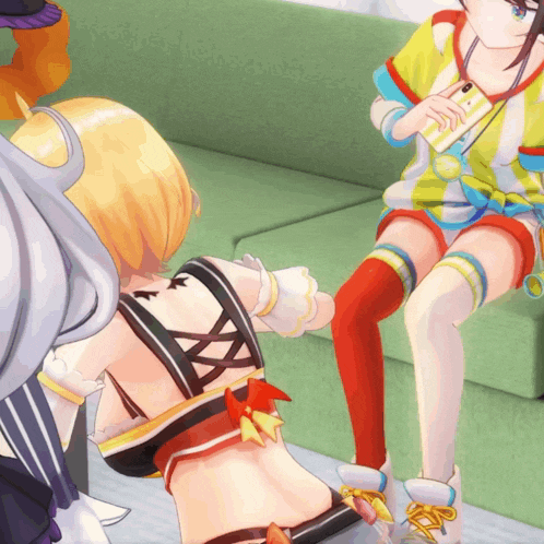 a group of anime girls are sitting on a couch and one of them is wearing red knee high socks