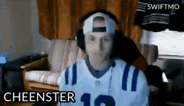 a man wearing headphones and a cheenster 12 jersey
