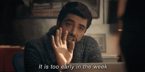 a man is sitting in front of a laptop and saying it is too early in the week