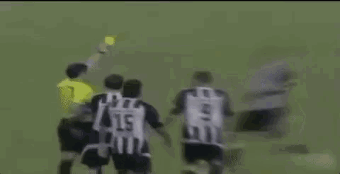 a group of soccer players are standing on a field and one of them has the letter ca on his shirt .