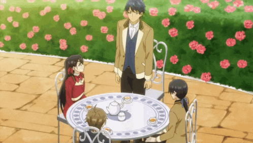 a group of people sitting around a table with teapots and cups