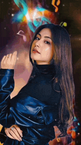 a woman wearing a black turtleneck and a blue leather jacket