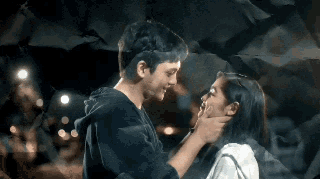 a man and a woman are looking at each other
